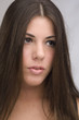 woman with shiny long brown hair.
