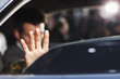 Man blocking photo in backseat of car