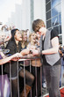 Celebrity signing autographs on red carpet