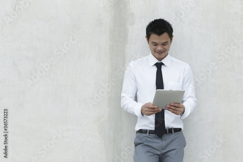 Photo: Asian Business man using a Digital Tablet Asian Business man using a Digital Tablet