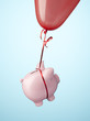 Piggy bank tied to balloon