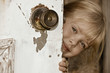 girl peeking around door