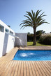 Pool with waterfall outside modern house
