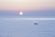 Boat on water at sunset