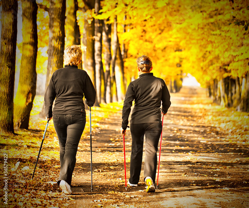 Photo: Two women in the park - Nordic walking Two women in the park - Nordic walking