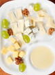 Cheese plate with grapes and honey