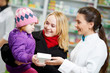 Pharmacy chemist, mother and child in drugstore