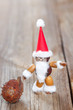 santa claus made of chestnuts,acorns and beechnuts on wooden boa