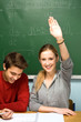 Clever student in classroom raising hand