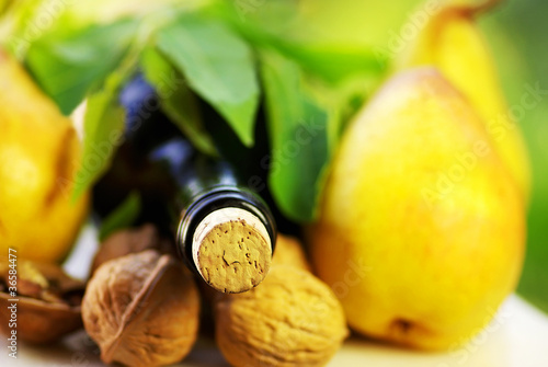 Photo: .Bottle of wine and wallnuts. .Bottle of wine and wallnuts.