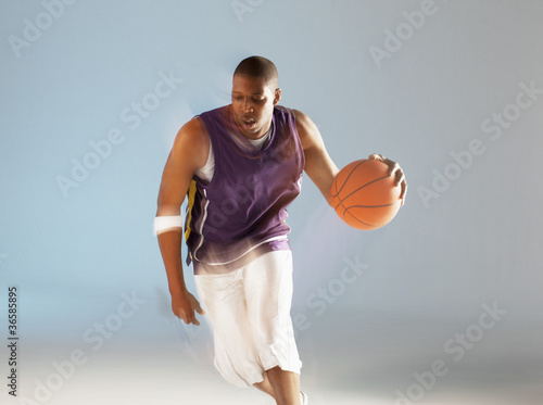 Photo: Blurred view of basketball player dribbling Blurred view of basketball player dribbling