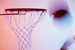 Blurred view of basketball going into hoop
