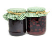 plum jam and preserved cherries in glass jar