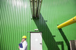 Technician talking on cell phone outside warehouse