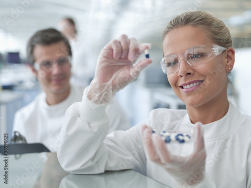 Photo: Scientist examining pills in lab Scientist examining pills in lab
