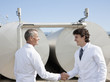 Technicians shaking hands outdoors
