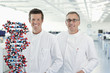Scientists with molecular model in lab
