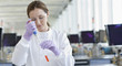 Scientist putting liquid into test tube in lab