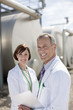 Scientists standing by tanks outdoors
