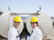 Scientists standing by tanks outdoors