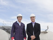 Businessman and worker standing together outdoors