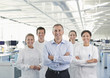Scientists and businessman smiling in lab