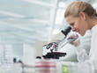 Scientist using microscope in lab