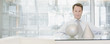 Businessman sitting at desk with sculptures