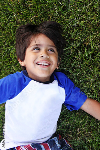 Photo: Happy Toddler Child Playing on the Grass Happy Toddler Child Playing on the Grass