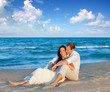 couple in love sitting in blue beach