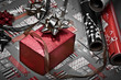 Red box with bow and wrapping paper in the background Red box with bow and wrapping paper in the background