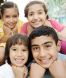 Vertical photo of children group, four friends smiling