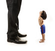 Little small child  is looking at the giant legs of  businessman