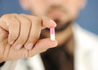 Doctor holding a pill, solution for you, closeup