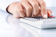 hand using calculator on white