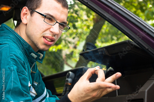 Photo: Man smoking in the car Man smoking in the car