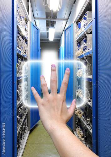 Photo: hand working on the communication and internet network server hand working on the communication and internet network server