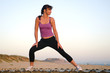 Photo: A woman stretching on the beach. A woman stretching on the beach.