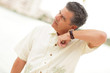 Photo: Man listening to his watch Man listening to his watch