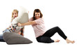 Playful young girls involved in a pillow fight