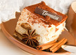 Cake tiramisu and a cup of hot coffee