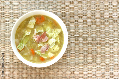 Photo: Vegetable cabbage soup in white bowl with bacon pieces Vegetable cabbage soup in white bowl with bacon pieces