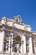 Trevi Fountain with a lamppost on the left and blue sky