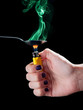 Woman with lighter heats up spoon with heroin. Drug is smoking