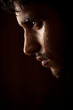 Young Indian angry man sweating over dark