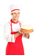 A smiling young chef holding a cake isolated on white background A smiling young chef holding a cake isolated on white background