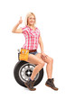 A smiling mechanic female giving a thumb up