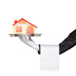 A waiter holding a silver tray with a house model on it A waiter holding a silver tray with a house model on it