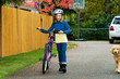 girl walking her bike with a helmet on