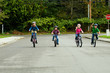 group of kids riding bikes with helmets on